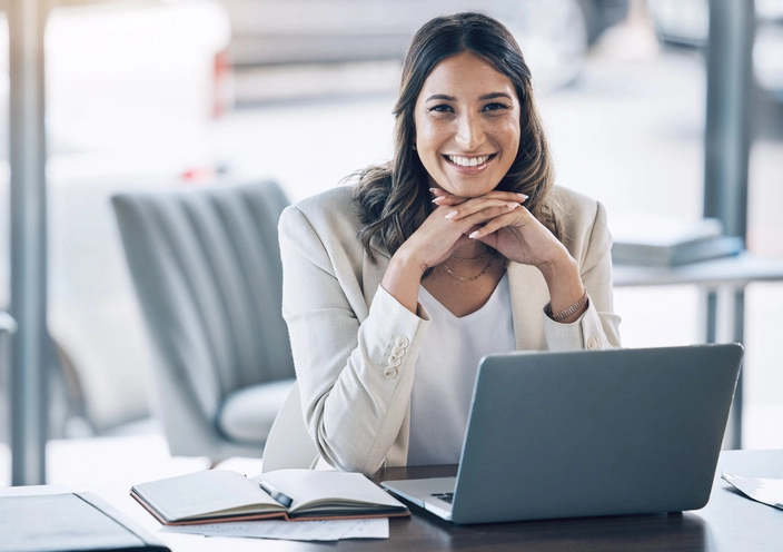 Female Attorney Smiling At Desk With Laptop
