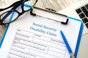 Social Security Disability Form Attached To Blue Clipboard With Pen