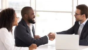 Attorney Shaking Hands With Black Couple Applying For Social Security disability benefits