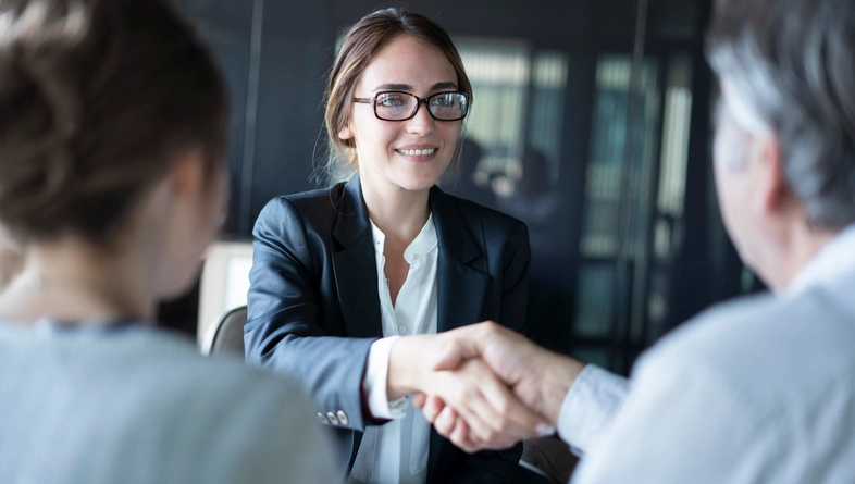Female Attorney With Glasses Shaking Hand With Client