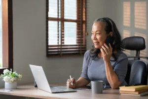 Older Woman Working Part-Time At Her Desk