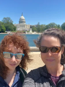 Michael Armstrong Law Managing Attorney Laura Johnson and Associate Attorney Marissa Basler Travel To DC May 2025 And Stand Outside On A Beautiful Day In Front Of The Capitol Building