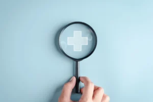 Magnifying Glass On Symbol Of Medical Cross